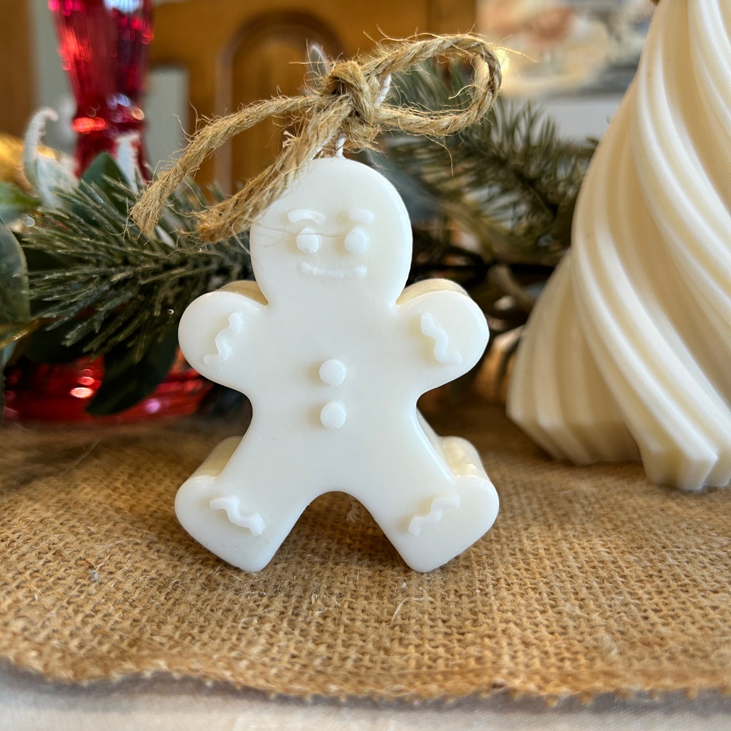snowman mini candle with Christmas decorations behind