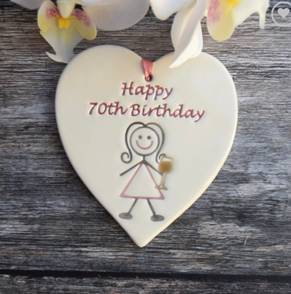 Happy70th Ceramic Gift Tag with a drawing of lady drinking and the text "happy 70th birthday"