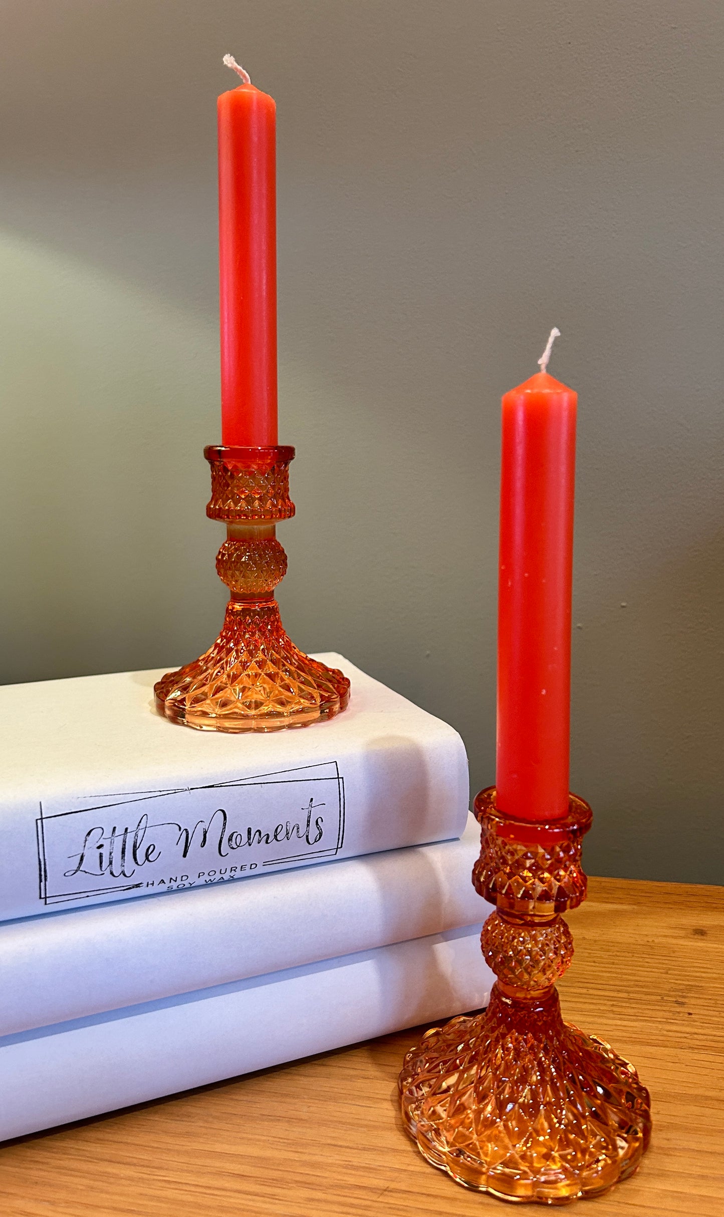 Orange glass candlestick holders with orange dinner candles