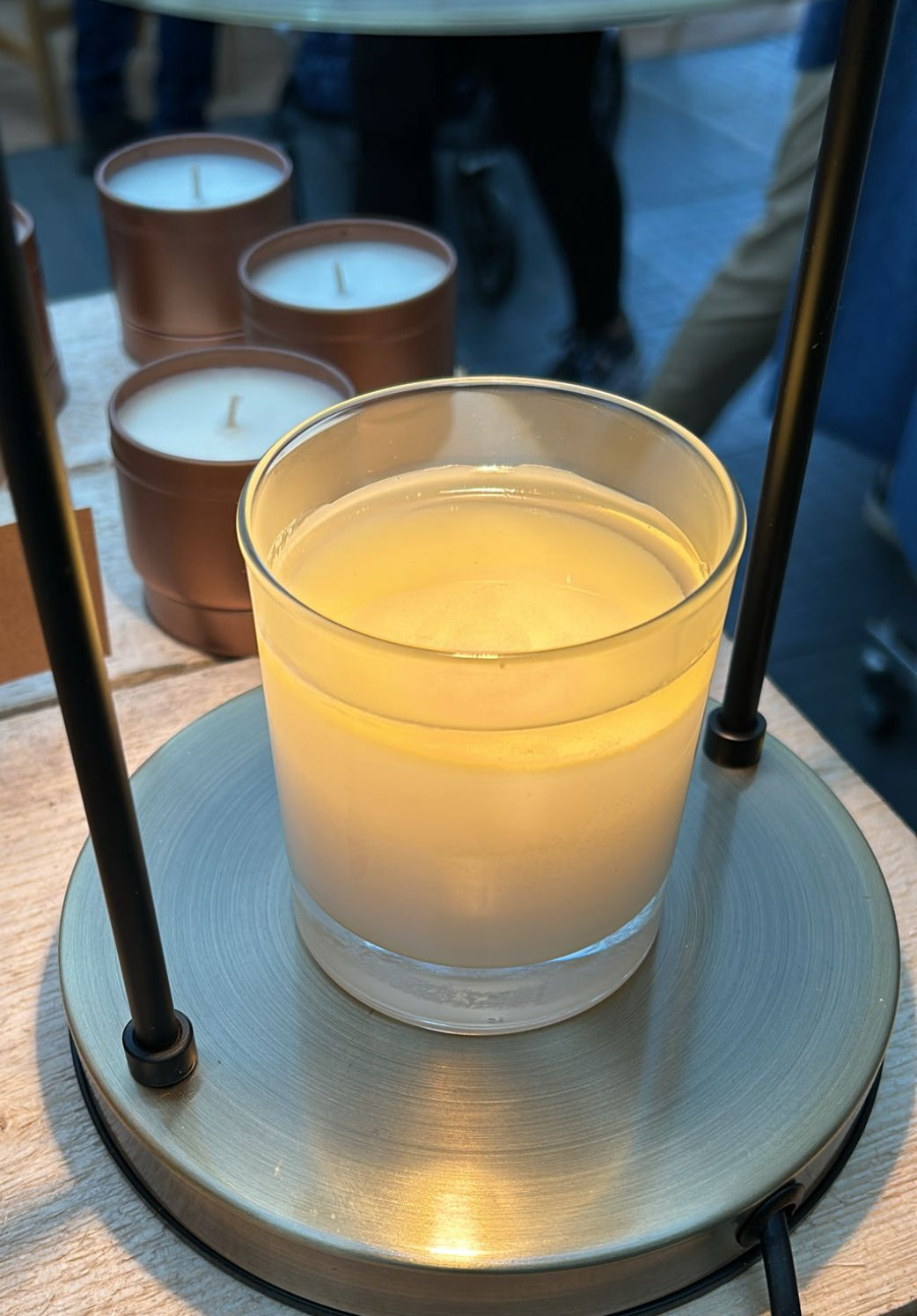 lit white candle in glass jar