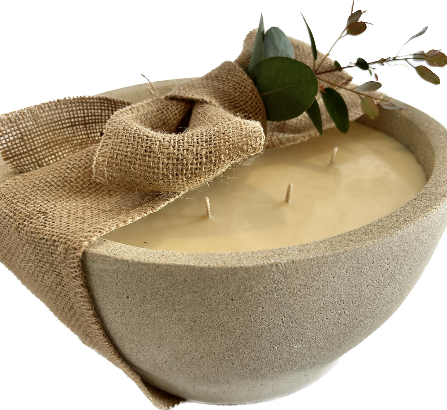 large bowl candle wrapped up in hessian bow and with foliage in the bow