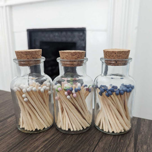 stylish glass jar with cork lid containing match sticks of various colours