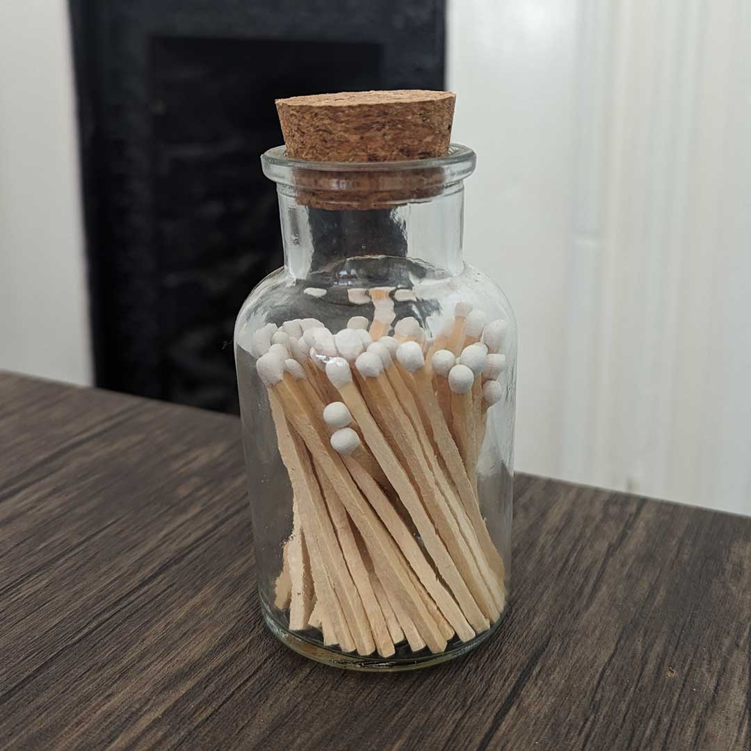stylish glass jar with cork lid containing white match sticks