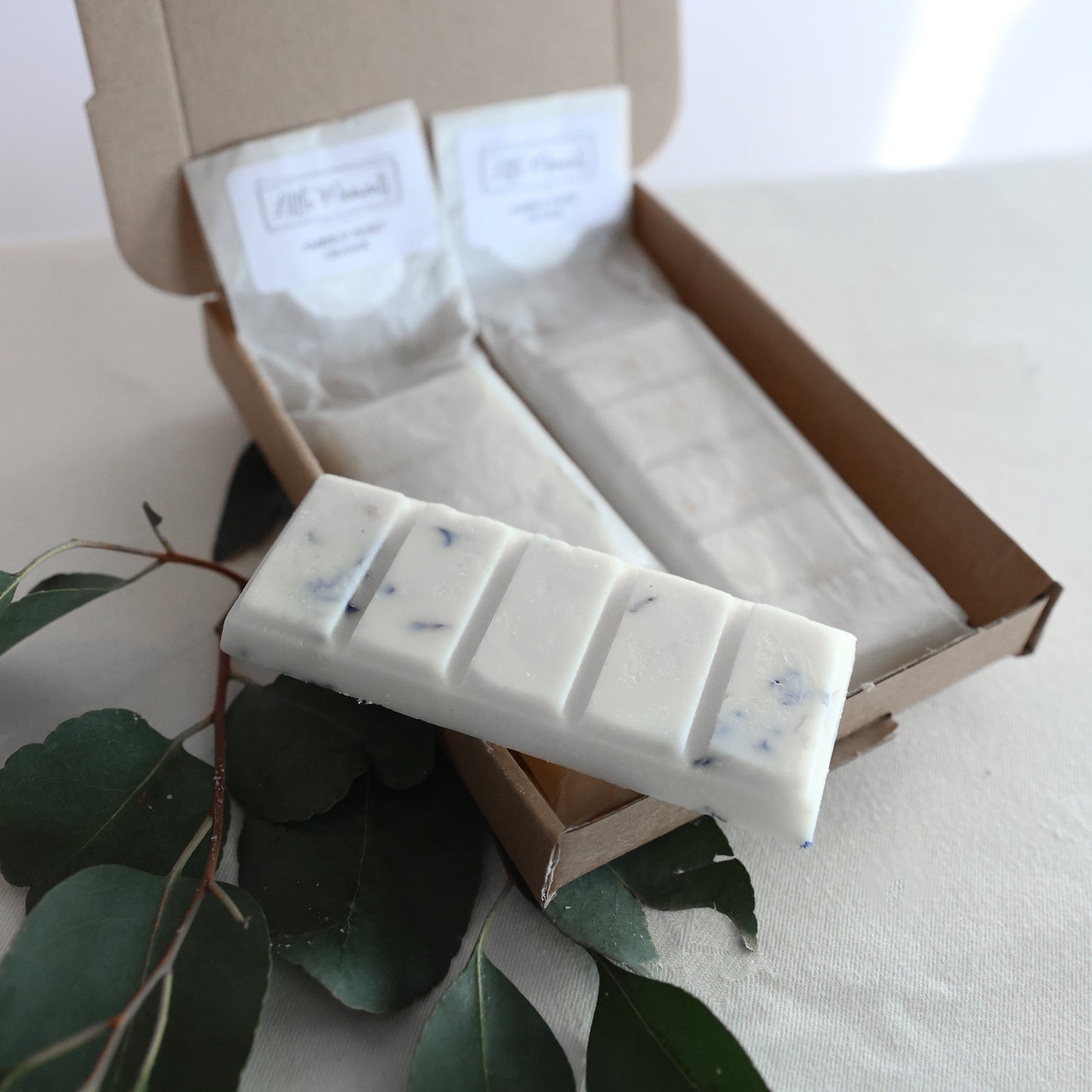 postal box containing three hand poured soy wax melt bars in various fragrances