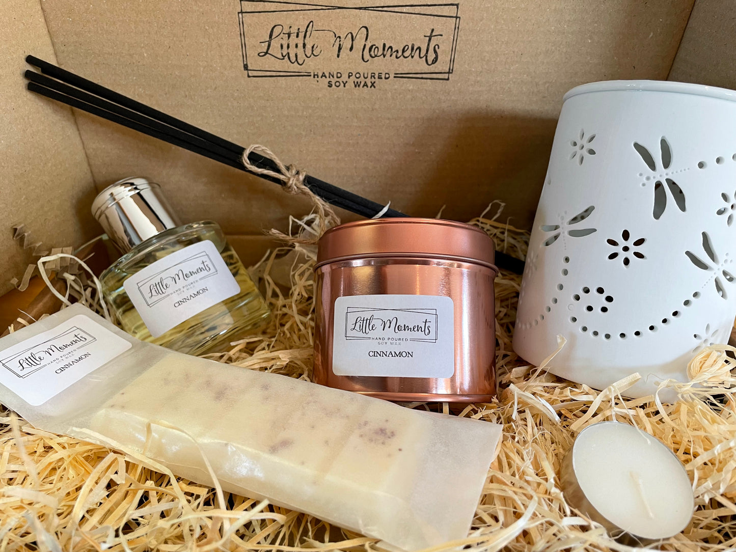 box gift set with a reed diffuser, soy wax candle in a rose gold tin, dragonfly ceramic wax melt burner and a wax melt snap bar