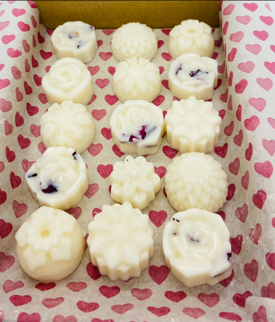 postal box of hand poured soy wax melts in the shape of various flowers available in a wide range of fragrances