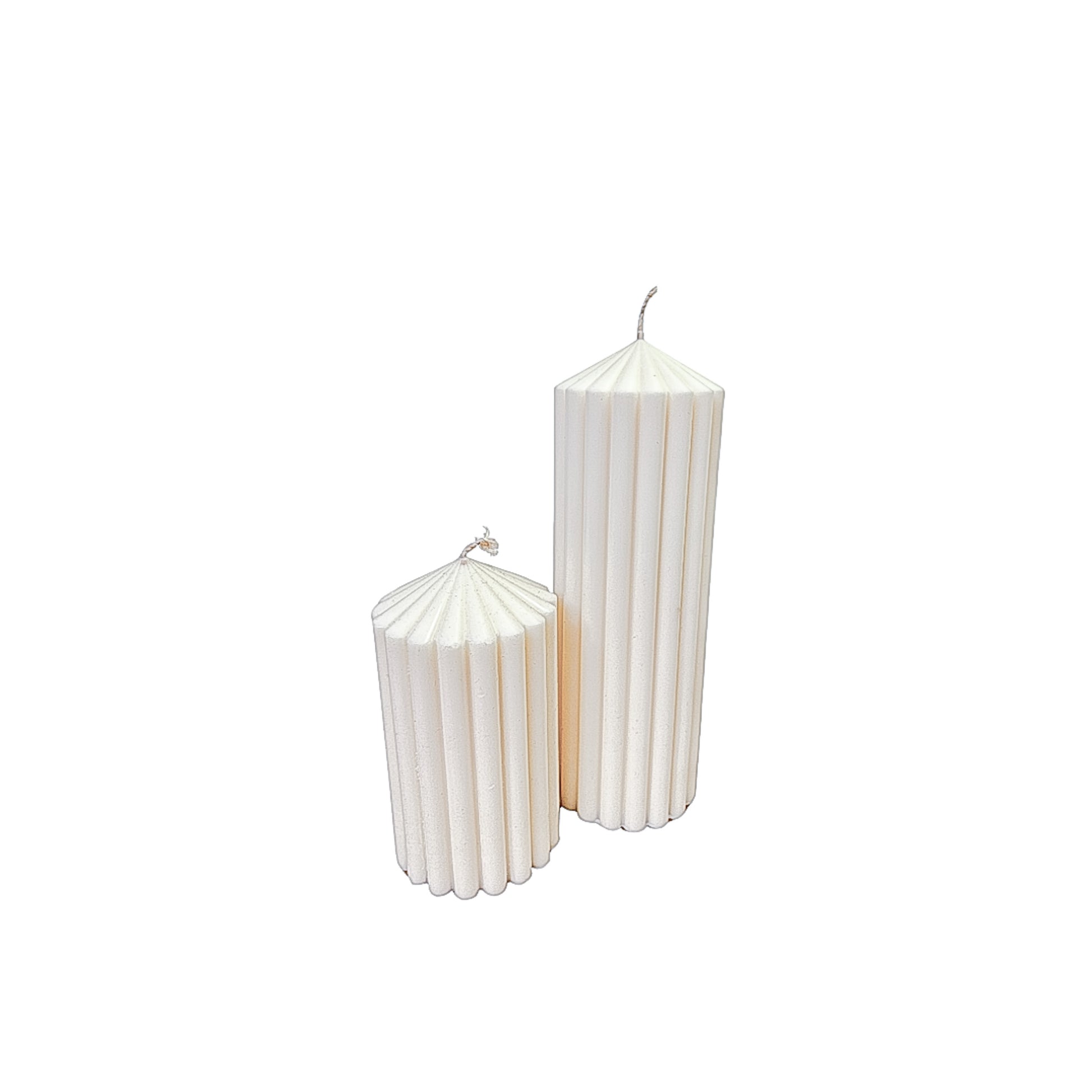 two hand poured soy wax ribbed pillar candles on white background
