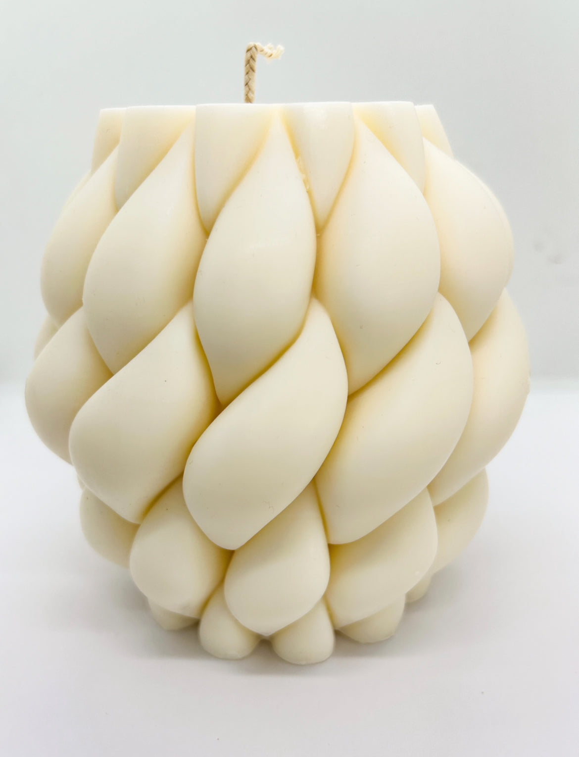 Large braid knot candle made with soy wax, styled as a home centerpiece
