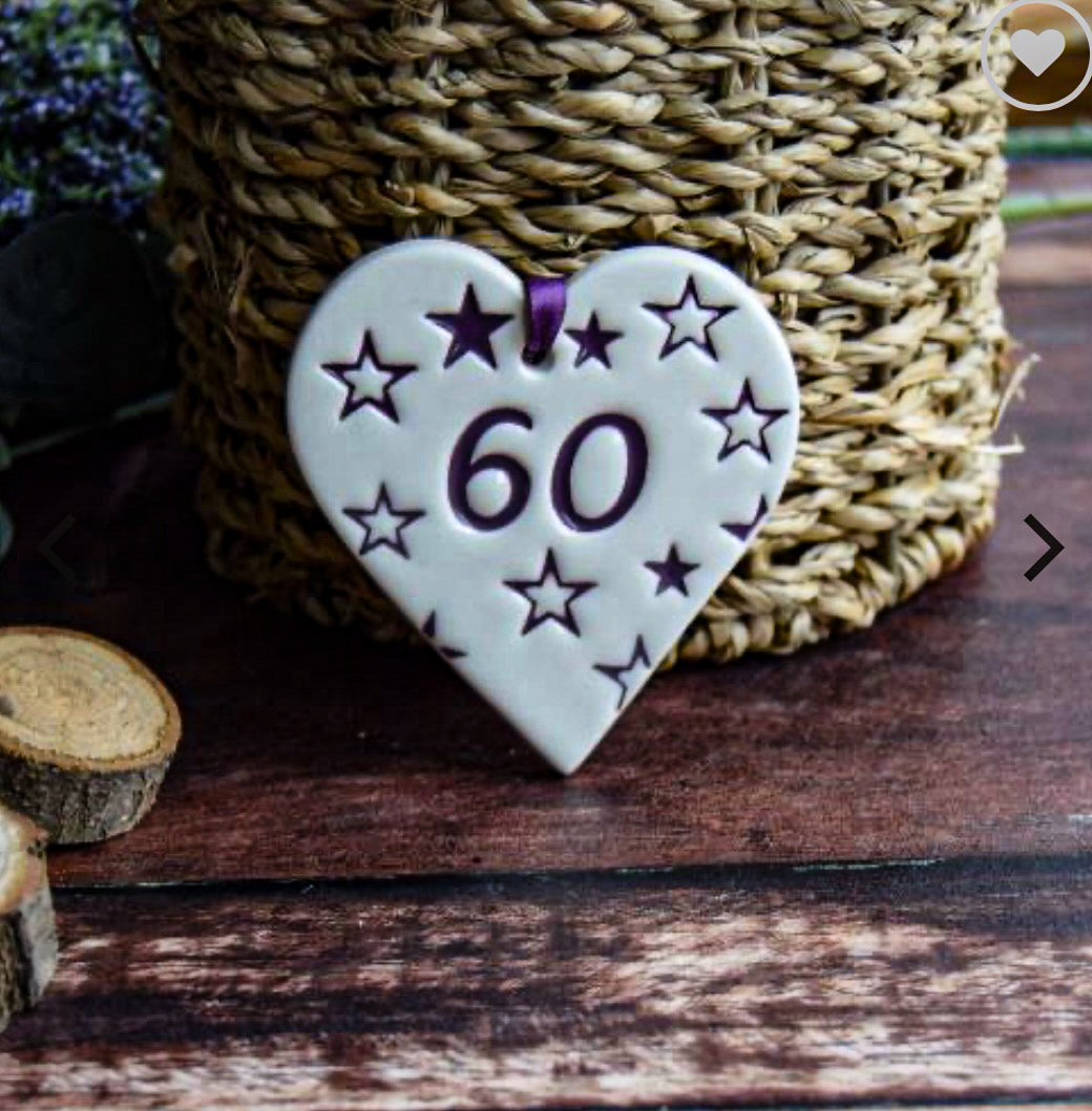 ceramic gift tag in the shape of a heart with the text "60" with purple stars
