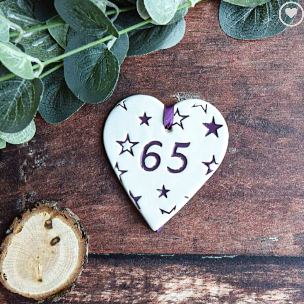ceramic gift tag, with the text "65" surrounded by purple stars
