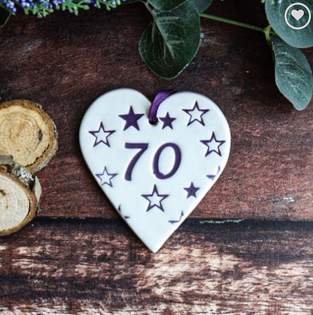 ceramic gift tag with the text "70" surrounded by purple stars 