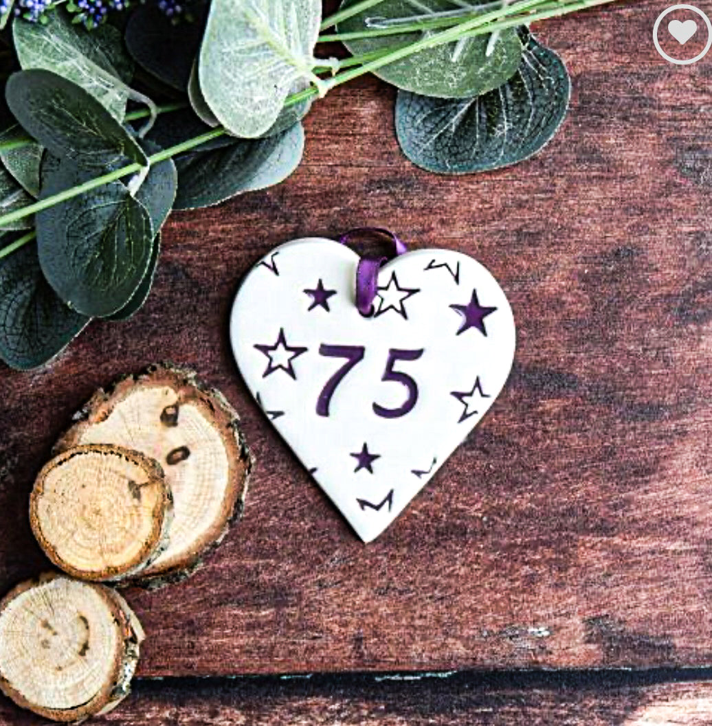ceramic gift tag with the text "75"  surrounded by purple stars 
