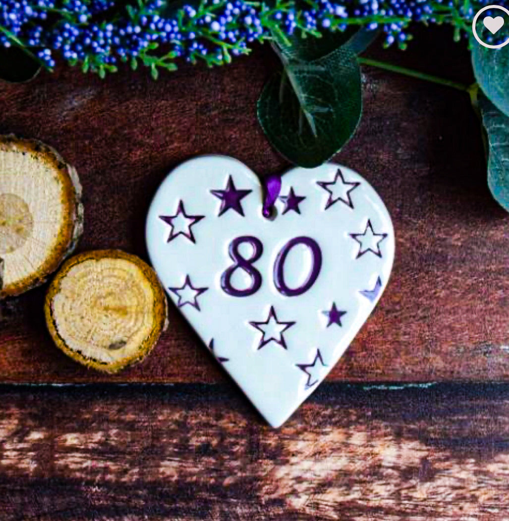 ceramic gift tag wit the text "80" surrounded by stars 