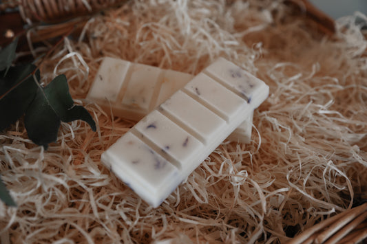 2 x wax melt snap bars sitting on shredded wood packaging