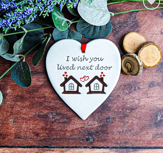 NextDoor Ceramic Gift. Tag with the text, "I wish you lived next door" with foliage around 