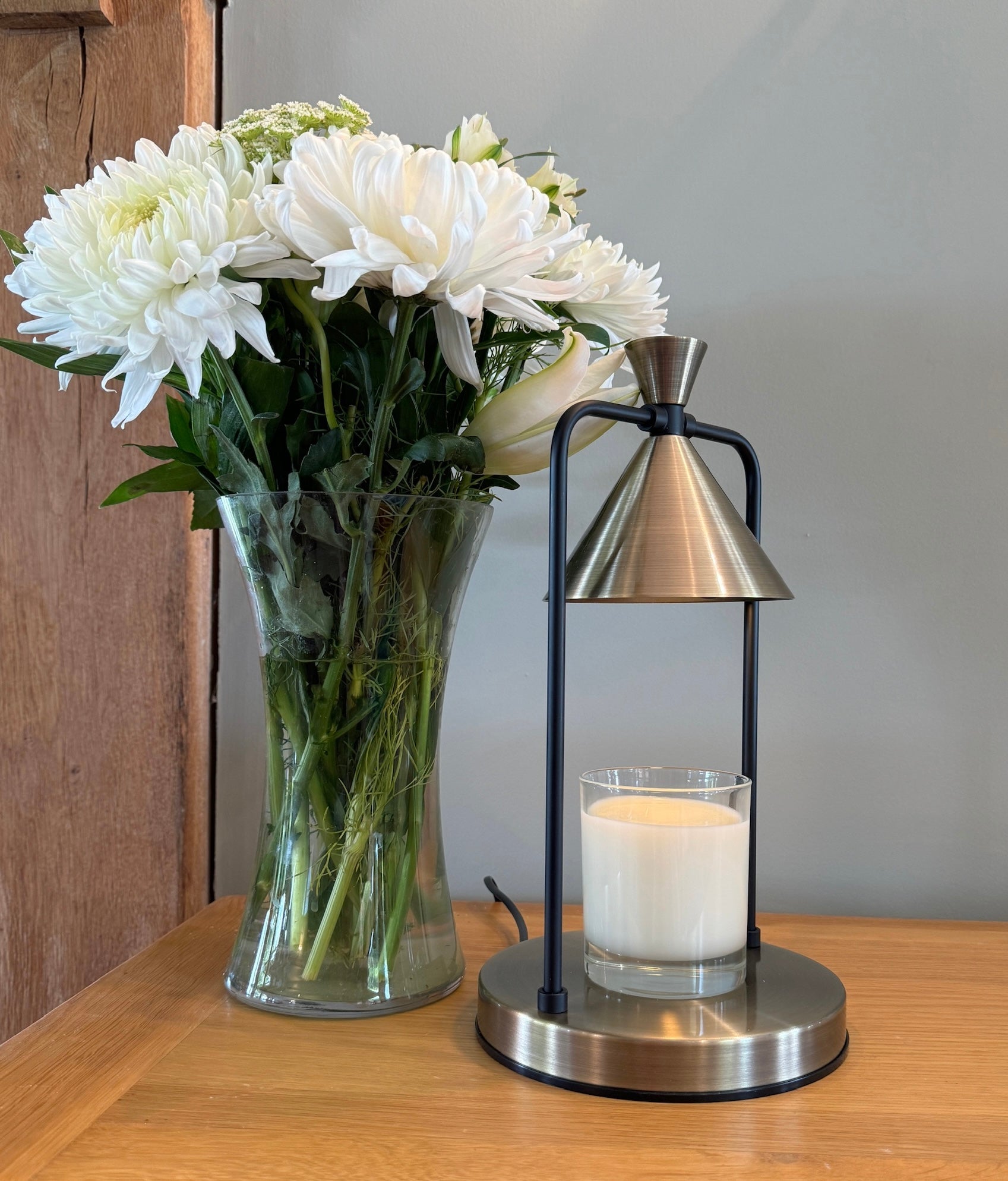 Electric Wax Melt Warmer Candle Lamp with flowers in a vase beside it 