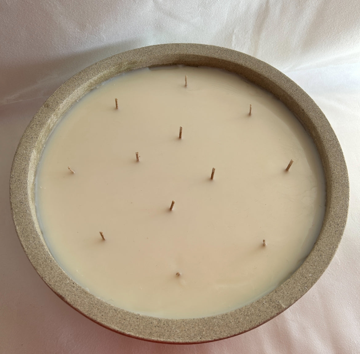 Large 12 wick candle in stone bowl, from above with all wicks unlit 