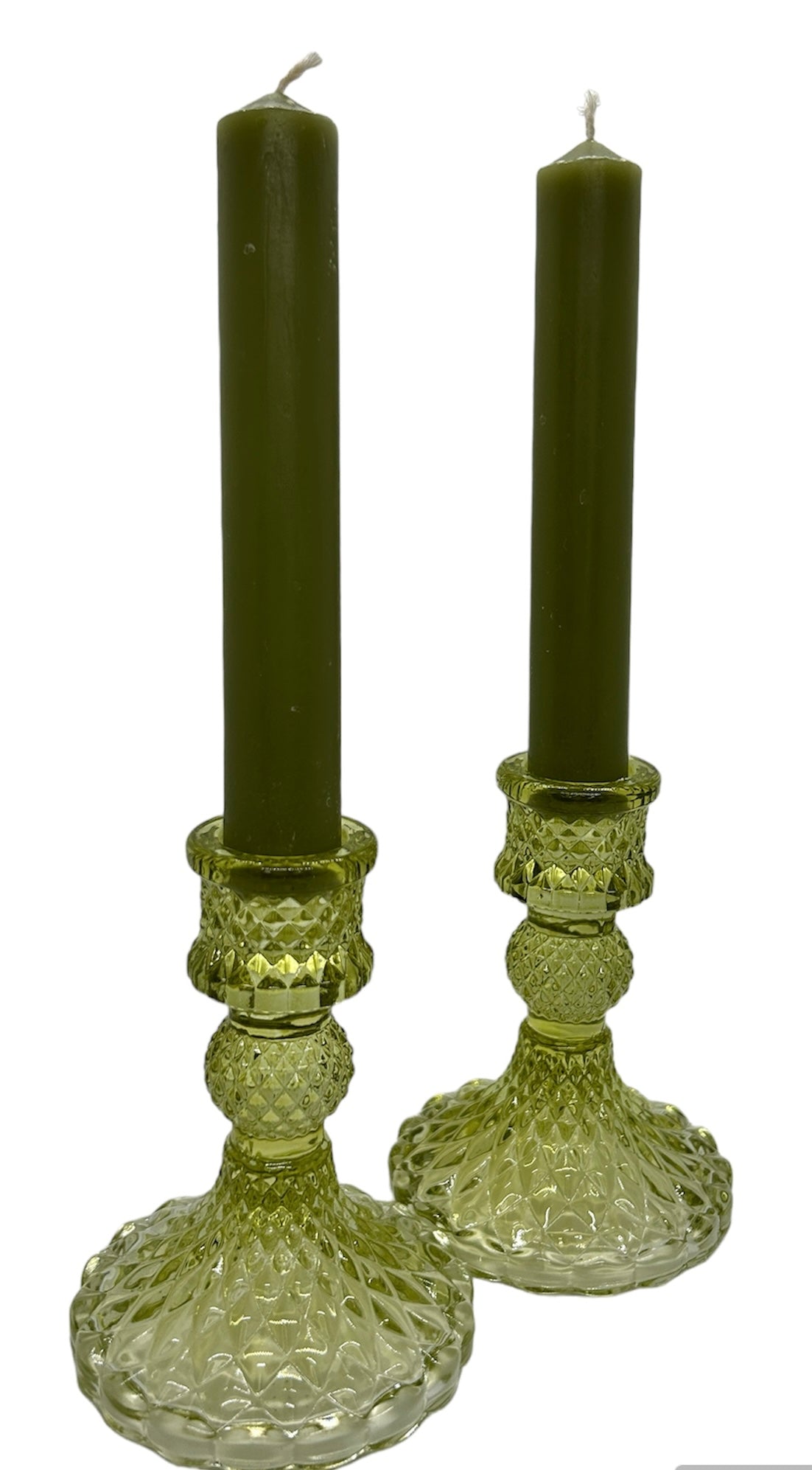 two green glass candle sticks with green dinner candles 