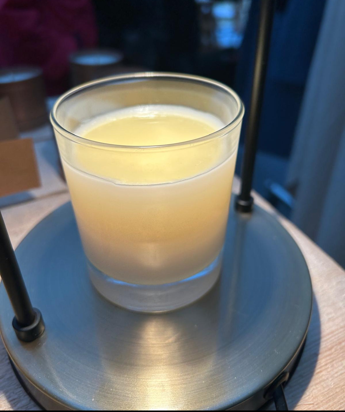 lit white candle in glass jar