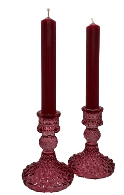 two pink glass candle sticks with pink dinner candles 