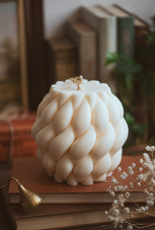 Large braid knot candle made with soy wax, styled as a home centerpiece