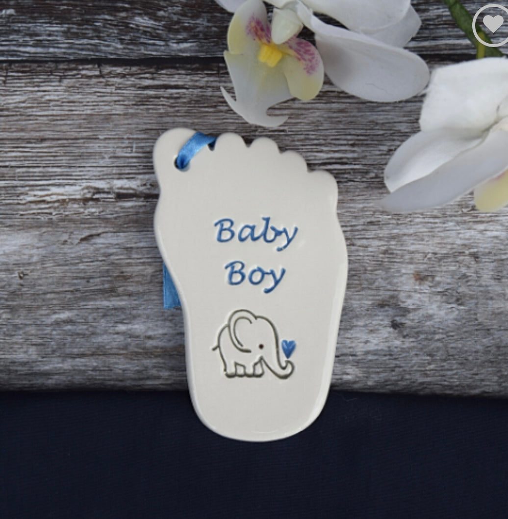 Ceramic tag in the shape of a babies foot with the words "baby boy" in blue writing  and elephant drawing , a perfect  gift for a baby shower