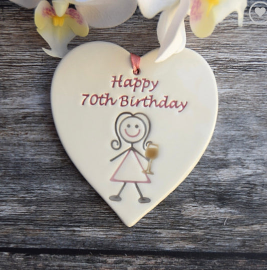 Happy70th Ceramic Gift Tag with a drawing of lady drinking and the text "happy 70th birthday"