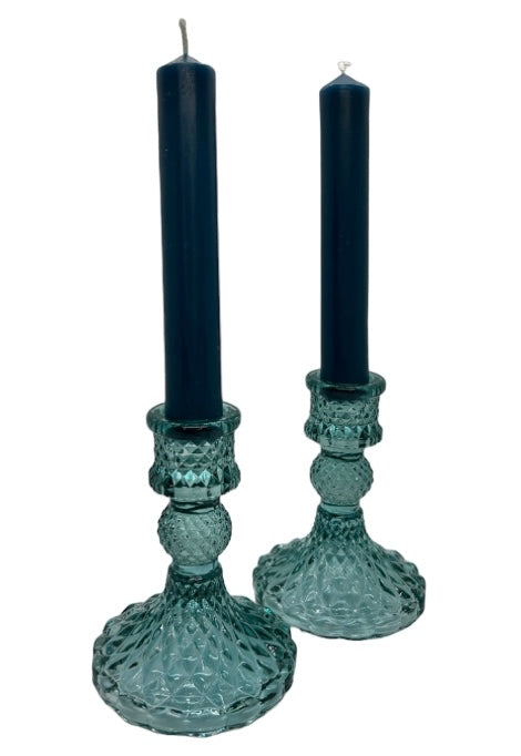 two blue glass candle sticks with blue dinner candles 