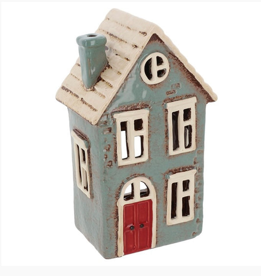 Grey ceramic talk house tealight holder with red door and white roof and window frames. windows are cutout. 
