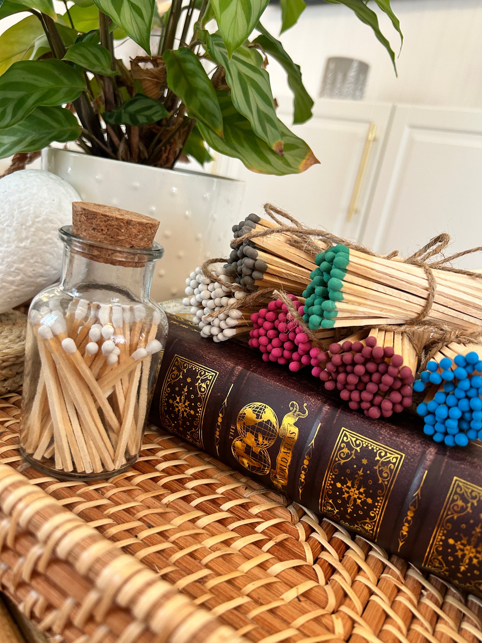 glass jar with cork lid containing long matches of varying colours