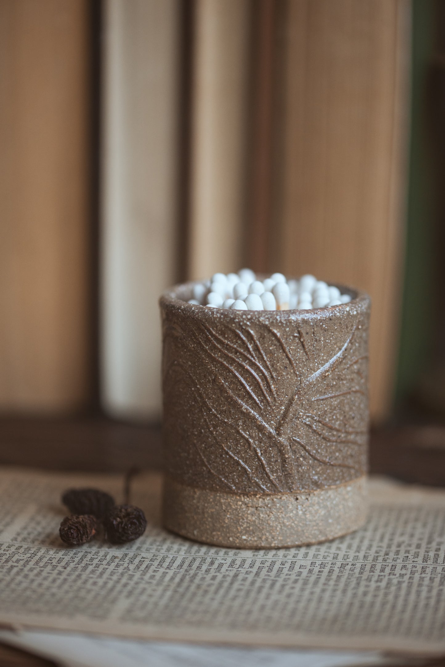 Ceramic container with textured surface on a textured surface