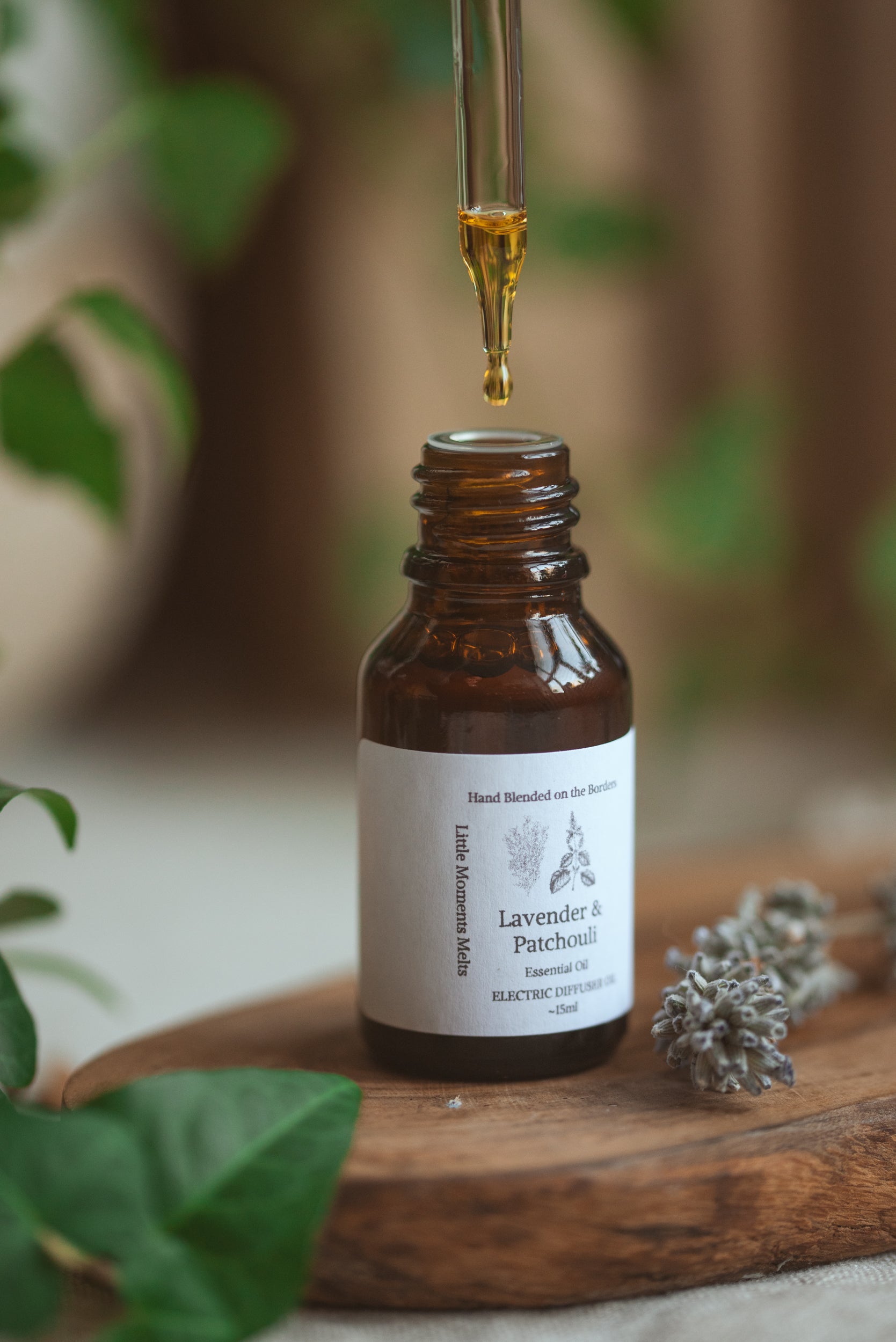 Brown droplet bottle with lavender in the picture 