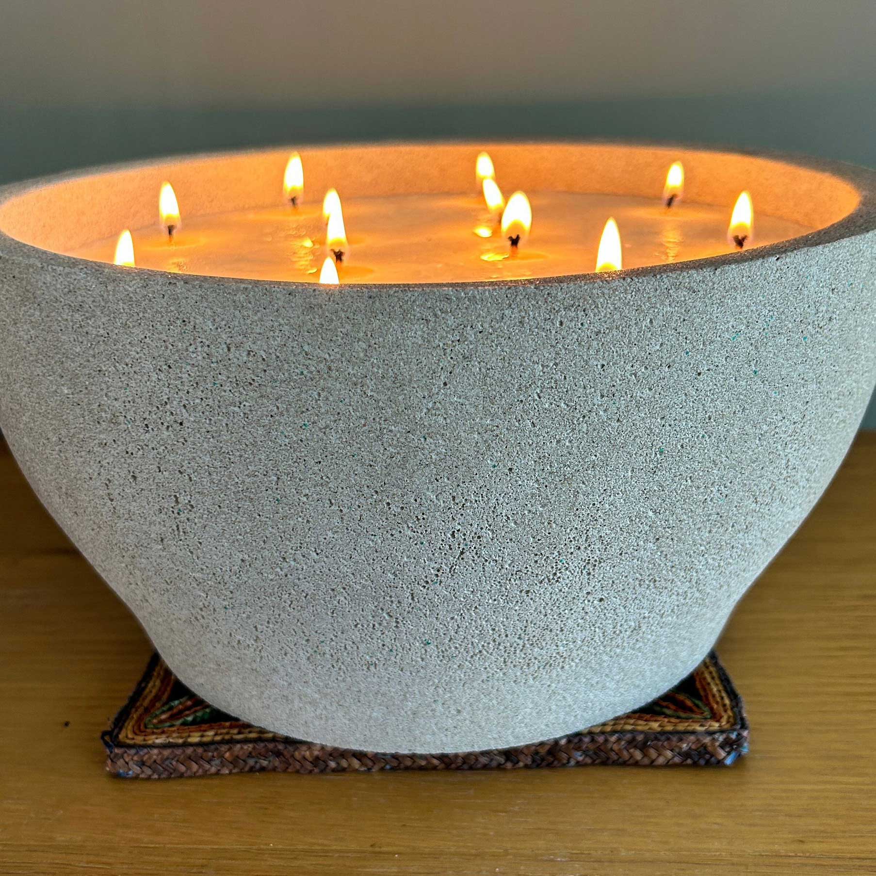 Extra large 12 wick candle lit from the side