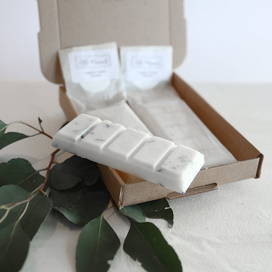 postal box containing three hand poured soy wax melt bars in various fragrances