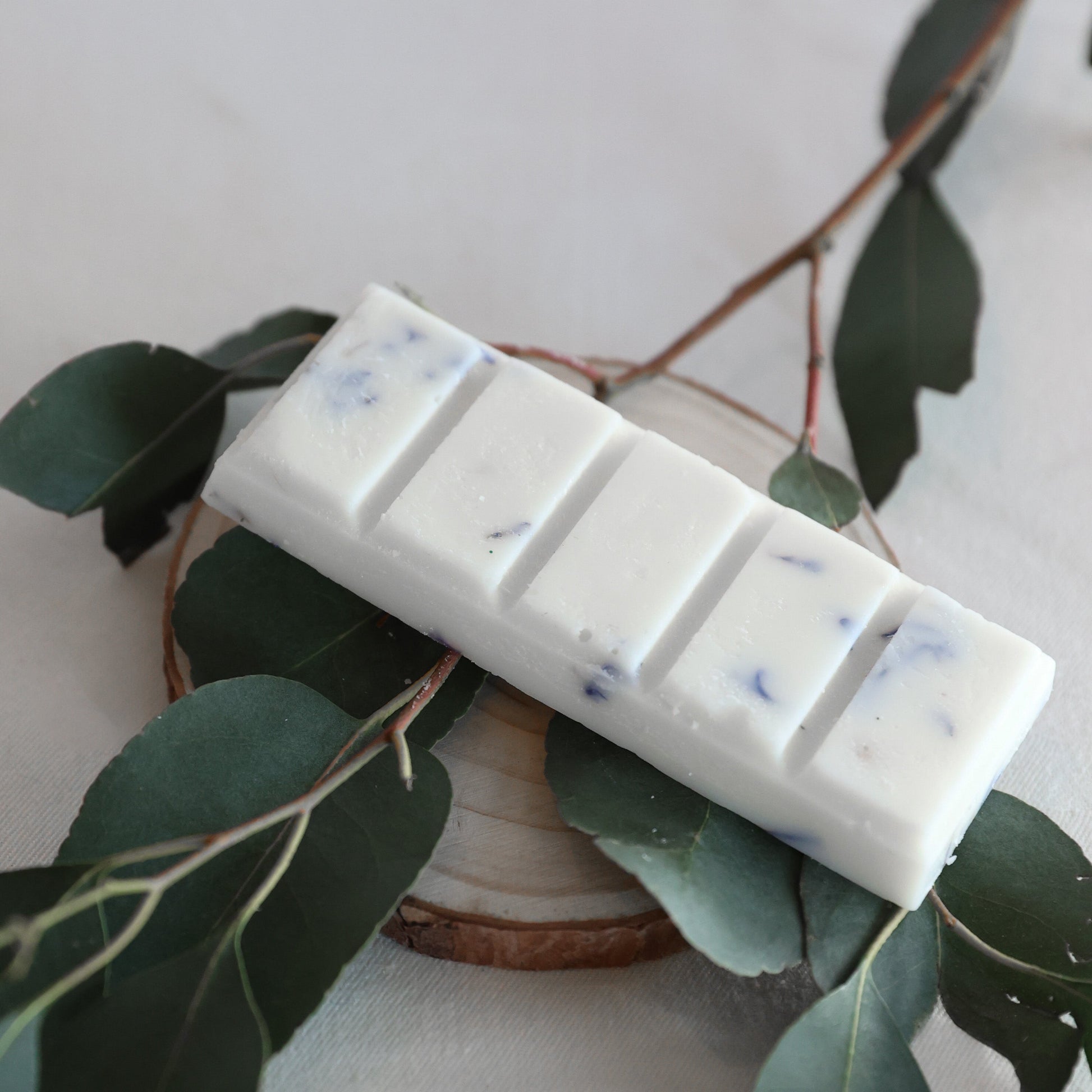 bar of soy wax melt bars with foliage underneath 